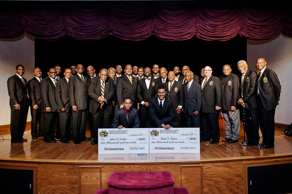 Alt text: Members of Epsilon Nu Lambda Chapter gather for the 12th annual Dr. Martin Luther King, Jr. Scholarship Breakfast. The image captures the moment of presentations to two scholarship recipients and the recognition of the 2016 Dr. Hugo A. Owens, Sr. Humanitarian Award honorees during the event.